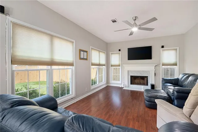 a large living room with couches a coffee table and a chandelier