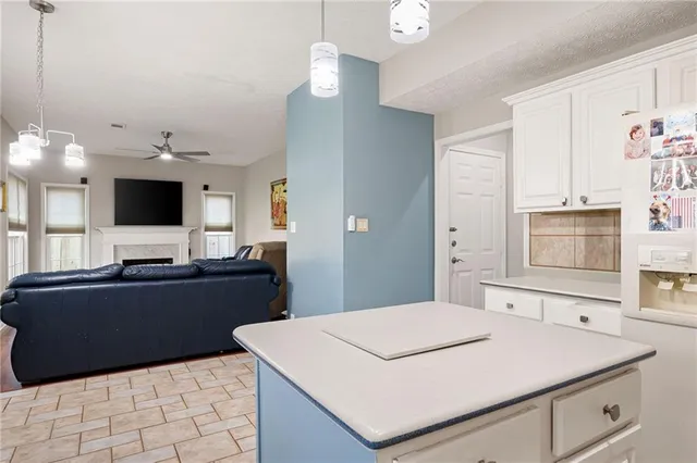 a kitchen with granite countertop a sink stove and cabinets