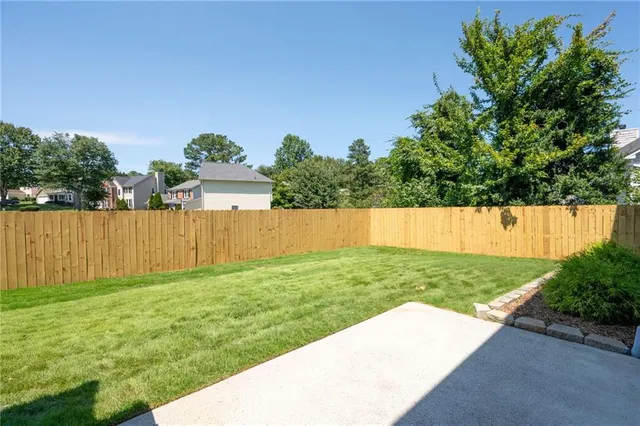 a view of a house with a backyard