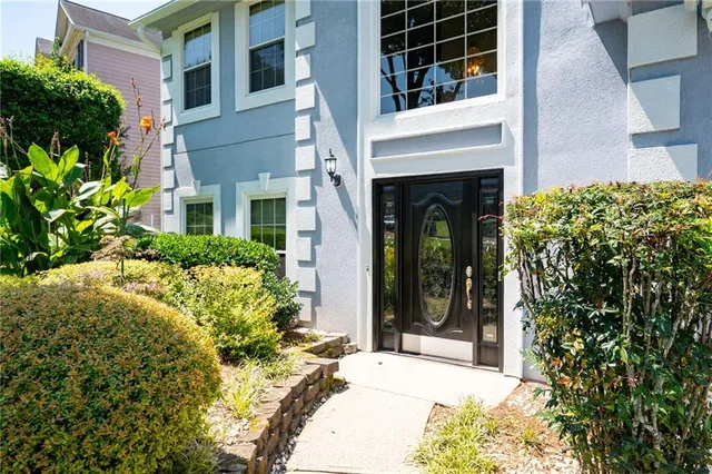 a view of a house with potted plants