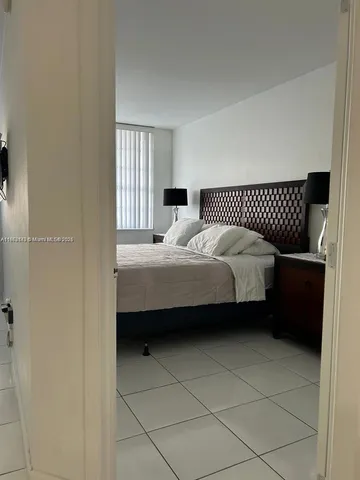 a bedroom with a bed dresser and a window