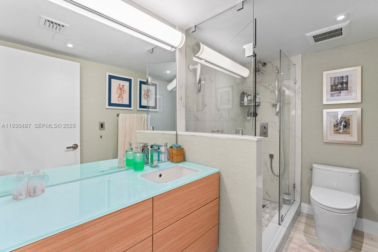 1450 Lincoln Road, Unit 307 Miami Beach, FL 33139 - Photo 12 of 18 a bathroom with a sink a toilet and shower
