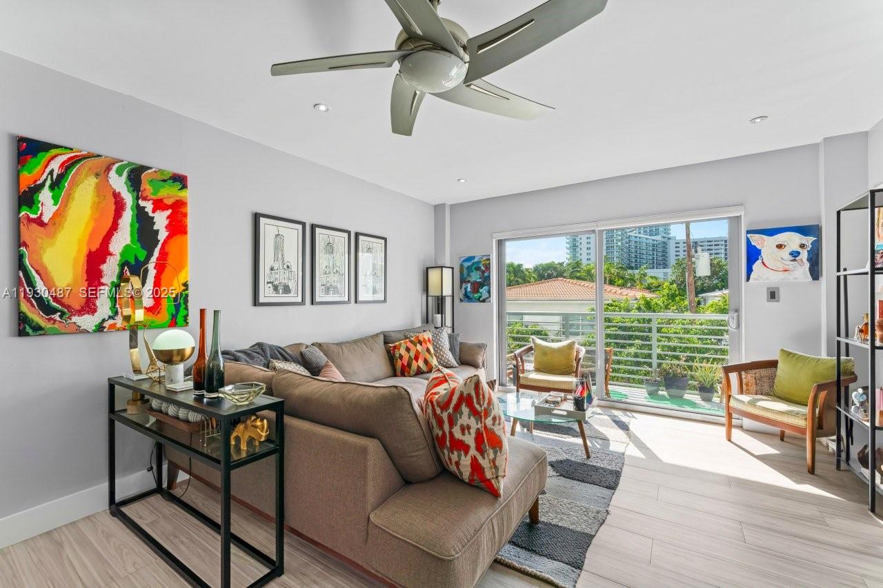 1450 Lincoln Road, Unit 307 Miami Beach, FL 33139 - Photo 2 of 18 a living room with furniture and a large window