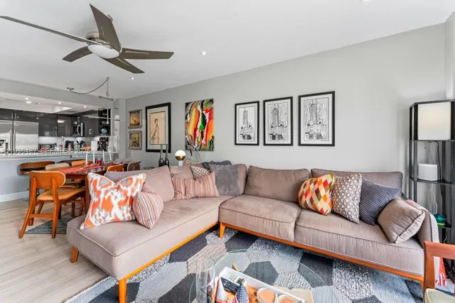 a living room with furniture ceiling fan and a rug