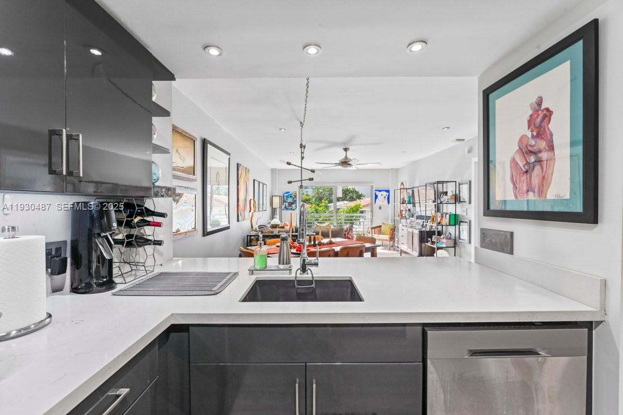 1450 Lincoln Road, Unit 307 Miami Beach, FL 33139 - Photo 6 of 18 a kitchen with a sink a counter space appliances and cabinets