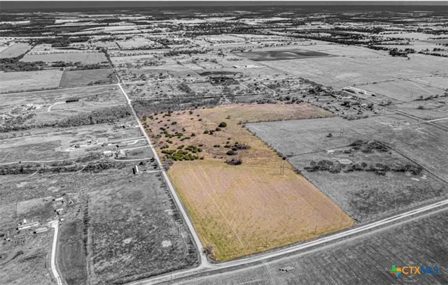 a view of a field with an ocean