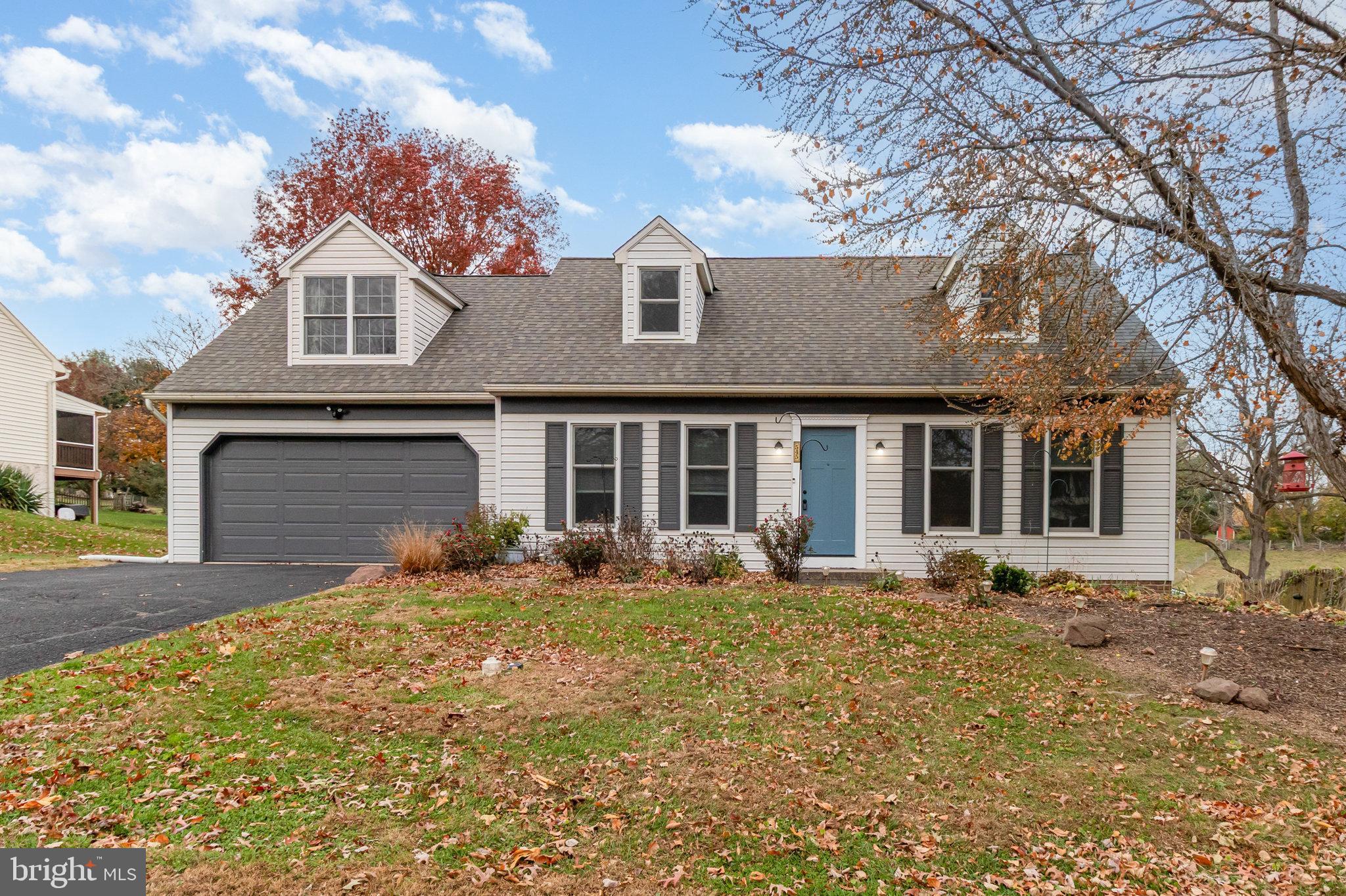 a front view of a house with yard fire pit and outdoor seating