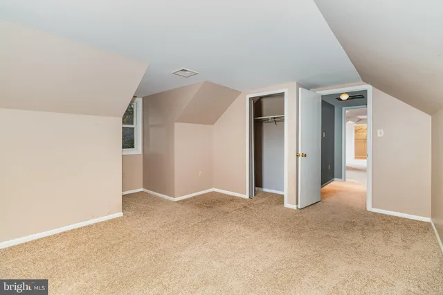 an empty room with closet and windows