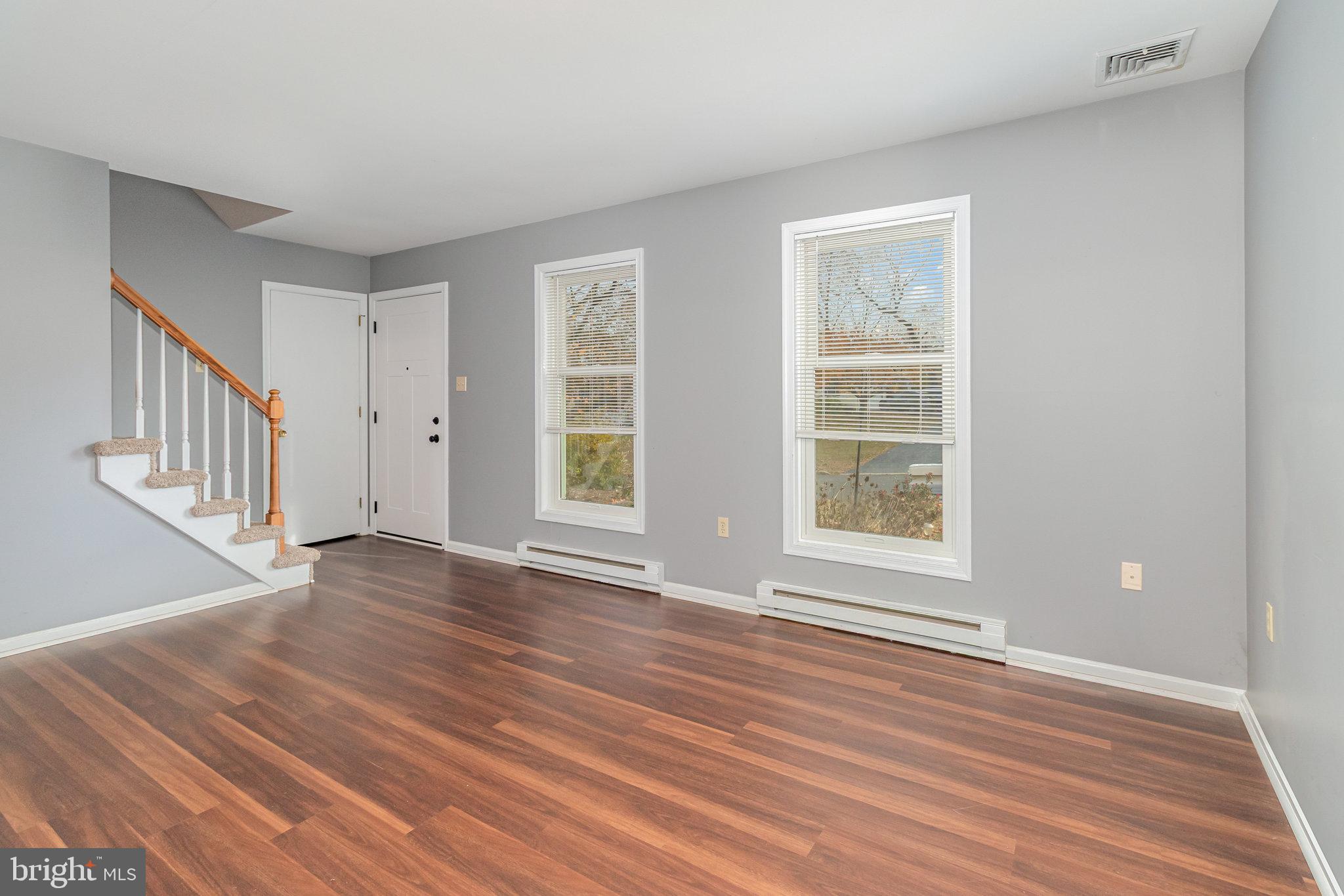 545 Wood View Drive Lititz, PA 17543 - Photo 4 of 38 a view of an empty room with wooden floor and windows