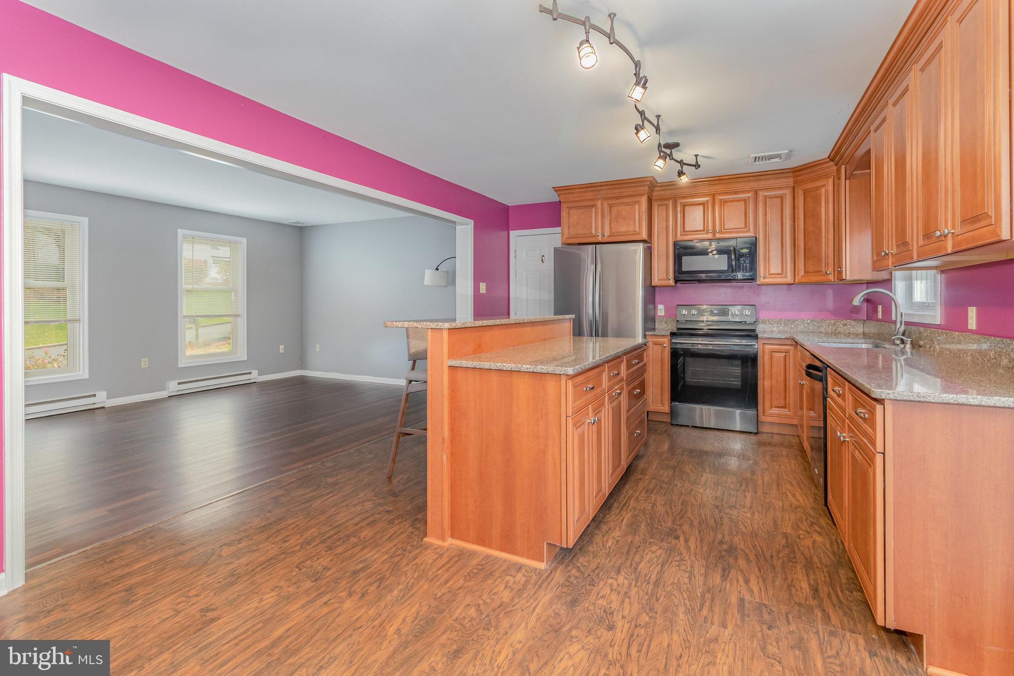 545 Wood View Drive Lititz, PA 17543 - Photo 6 of 38 a kitchen with stainless steel appliances granite countertop a sink a stove top oven a refrigerator with wooden floors