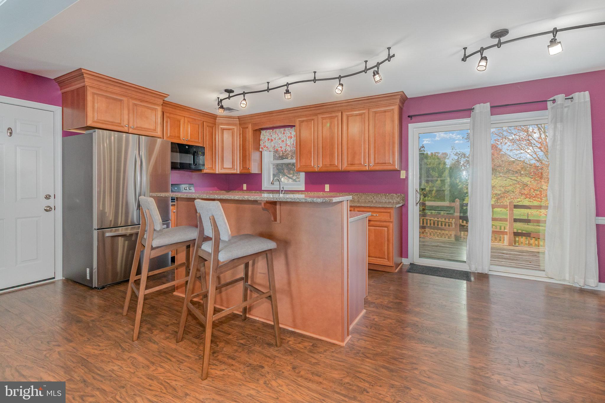 545 Wood View Drive Lititz, PA 17543 - Photo 7 of 38 a kitchen with stainless steel appliances a dining table chairs refrigerator and cabinets