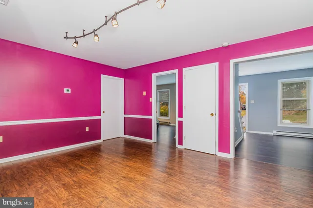 a view of a room with wooden floor