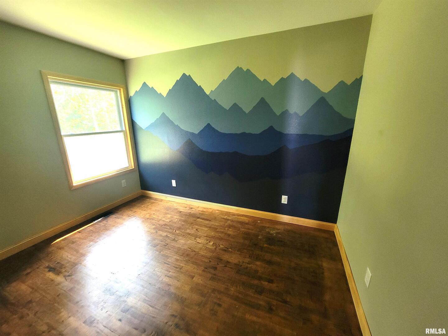 7324 State Rte 161 Extension Iuka, IL 62849 - Photo 23 of 78 a view of an empty room with wooden floor and a window
