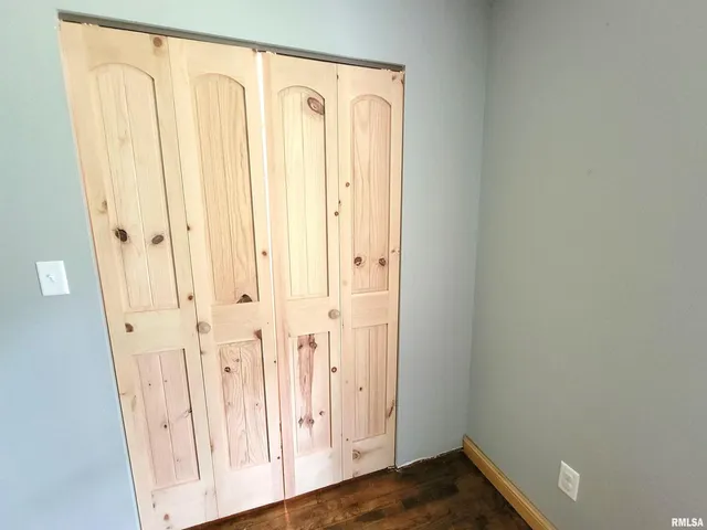 a living room with a couch wooden floor and a view of living room