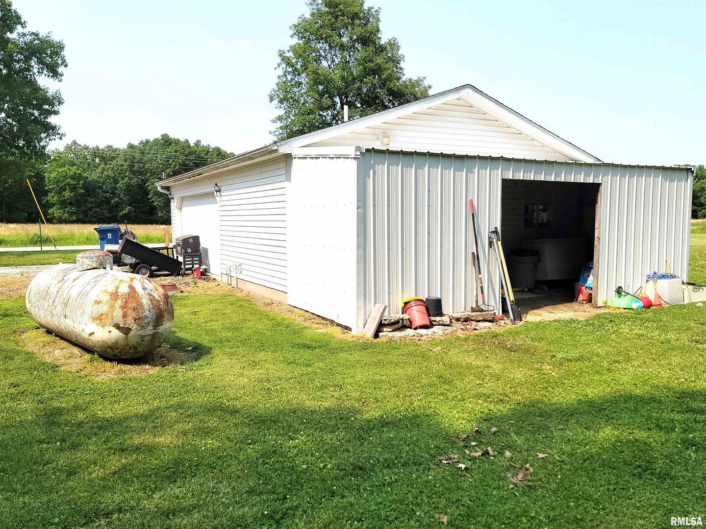 7324 State Rte 161 Extension Iuka, IL 62849 - Photo 61 of 78 a view of a backyard with table and chairs and a grill