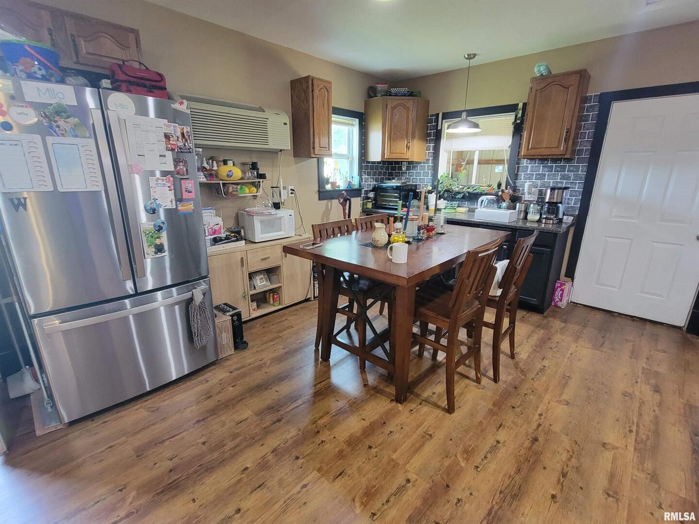 7324 State Rte 161 Extension Iuka, IL 62849 - Photo 67 of 78 a kitchen with stainless steel appliances a refrigerator a sink a stove a microwave a dining table and chairs