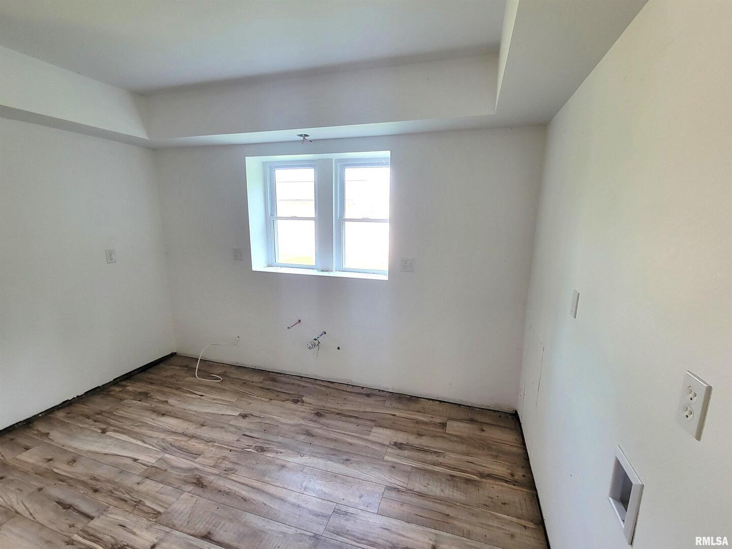 7324 State Rte 161 Extension Iuka, IL 62849 - Photo 8 of 78 wooden floor in an empty room with a window