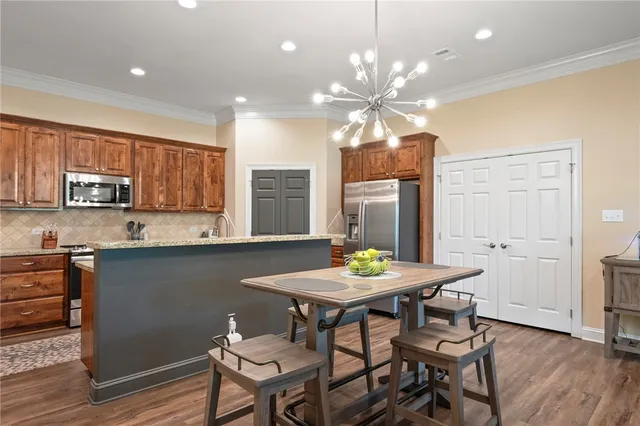 a kitchen with a table and chairs in it
