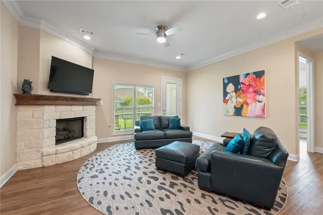 a living room with furniture a flat screen tv and a fireplace