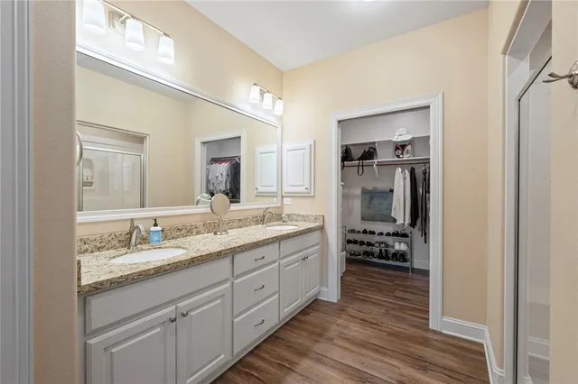a spacious bathroom with a granite countertop sink and a mirror