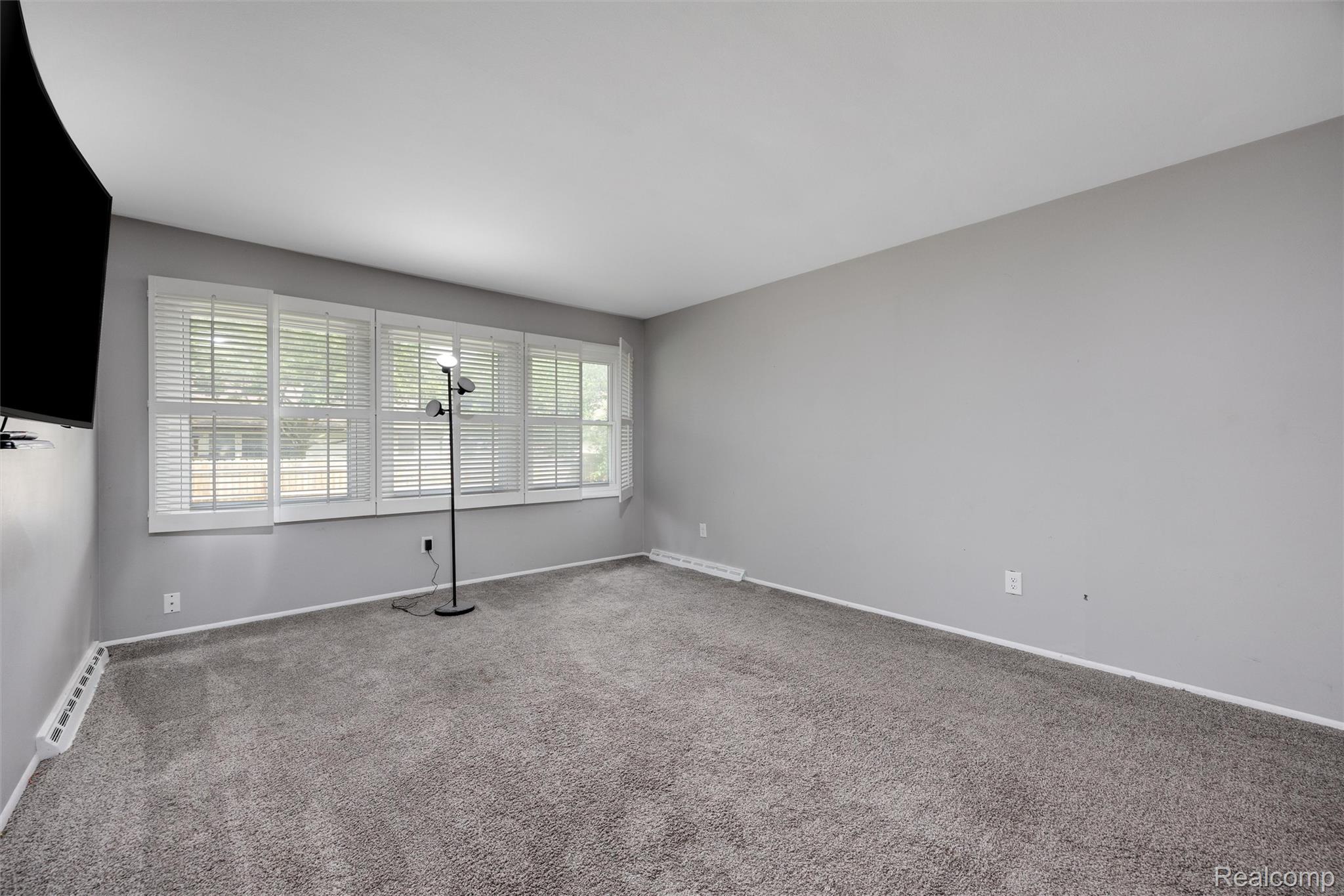 4942 Butler Drive Troy, MI 48085 - Photo 22 of 33 Spacious room featuring neutral gray wall paint, gray carpeting, and white baseboards