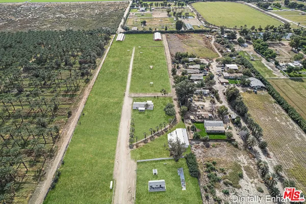 a green field with lots of tress in it