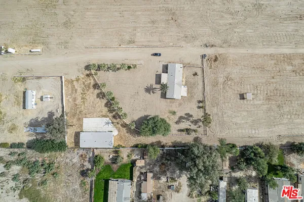 a view of a house with a yard and a mountain view
