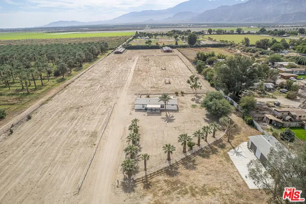 a living room with furniture a clock on wall and a clock