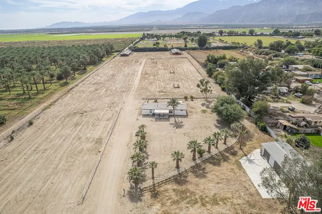 a living room with furniture a clock on wall and a clock