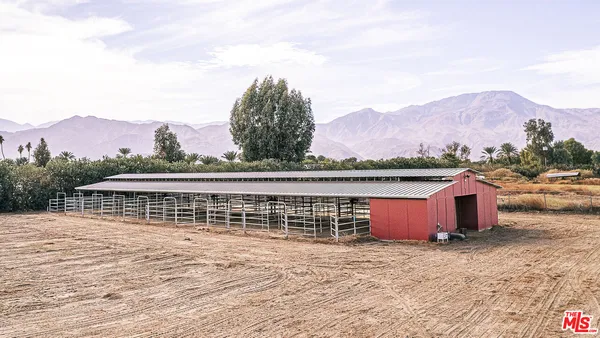 a kitchen with stainless steel appliances granite countertop a stove top oven a sink dishwasher a refrigerator and white cabinets with wooden floor