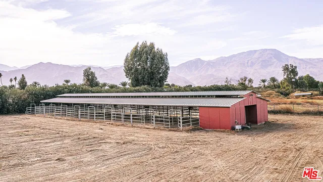 a kitchen with stainless steel appliances granite countertop a stove top oven a sink dishwasher a refrigerator and white cabinets with wooden floor