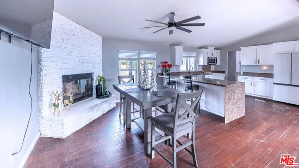 a bathroom with a granite countertop toilet sink and mirror
