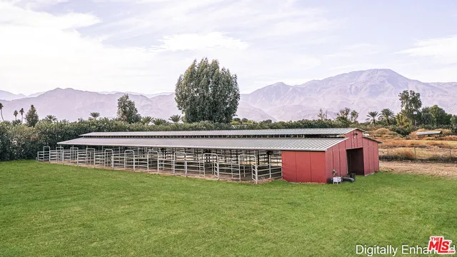 a view of a house with a big yard and large trees