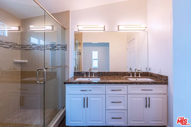 a bedroom with a bunk bed and a window