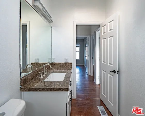 a kitchen with stainless steel appliances granite countertop a refrigerator and a stove