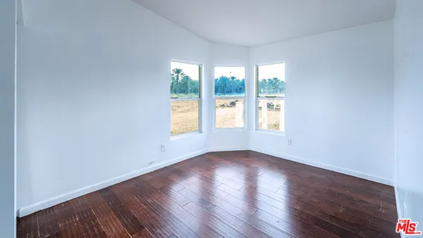 a kitchen with stainless steel appliances granite countertop a stove and a view of living room