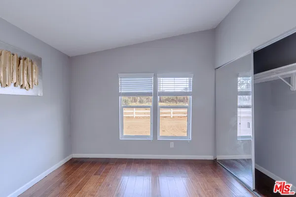 a workspace with furniture wooden floor and a window
