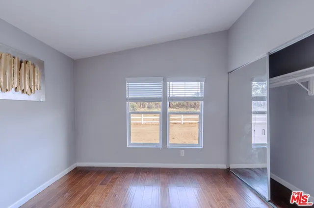 a workspace with furniture wooden floor and a window
