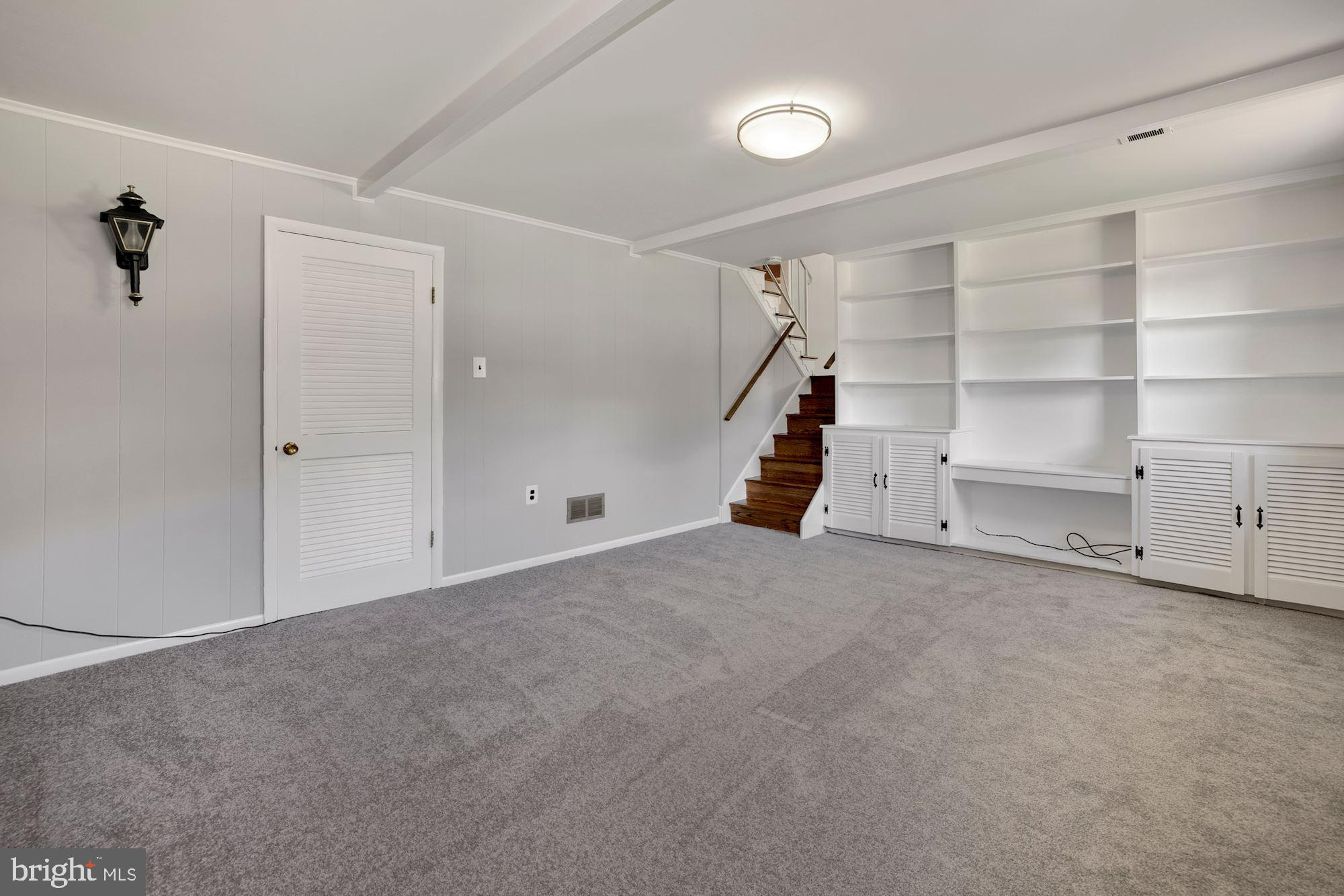 4105 Weller Road Silver Spring, MD 20906 - Photo 19 of 29 LOWER LEVEL LIVING AREA W/ BUILT-IN BOOKCASES