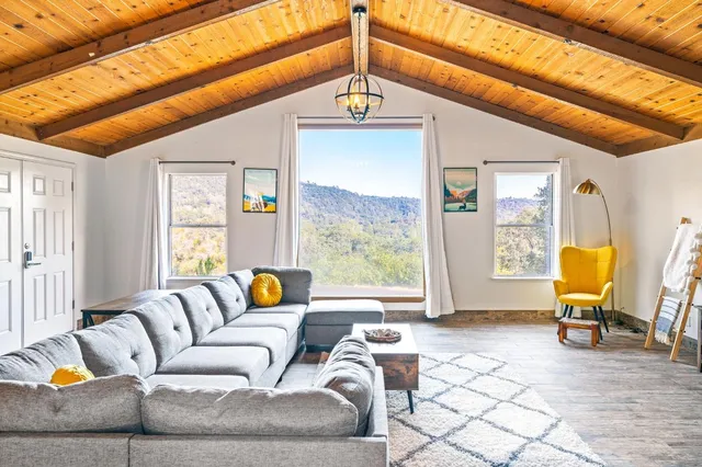 a living room with furniture and a floor to ceiling window