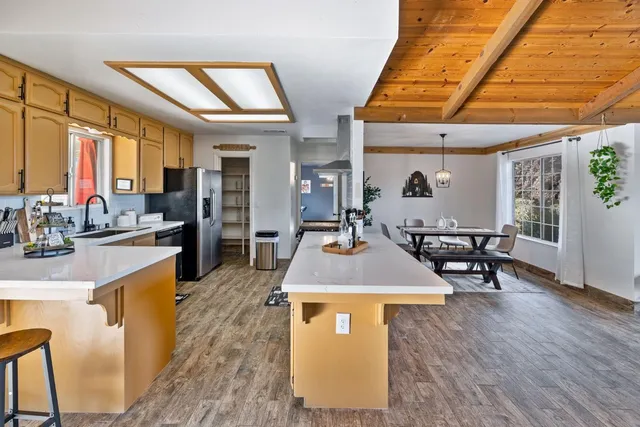 a view of a living room and kitchen