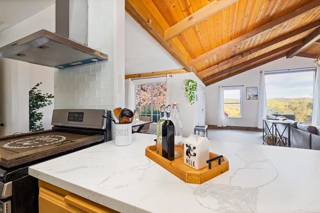 a kitchen with a stove a refrigerator and a dining table