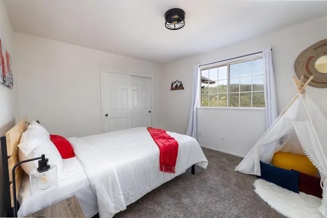 a bedroom with a bed and a window