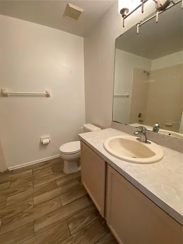 a bathroom with a sink and mirror with toilet