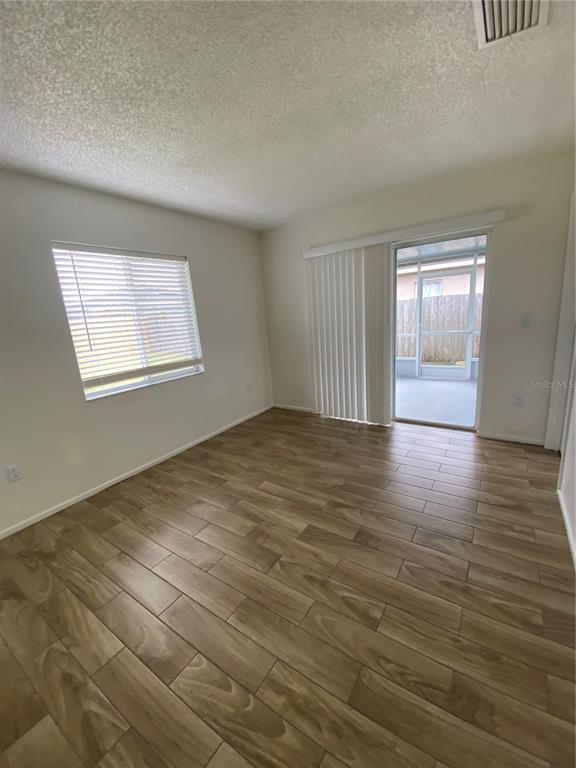 1258 Franford Drive Brandon, FL 33511 - Photo 8 of 20 an empty room with wooden floor and windows