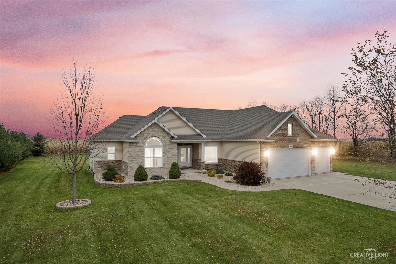 2969 4459th Road Newark, IL 60541 - Photo 2 of 35 a front view of a house with a garden and plants