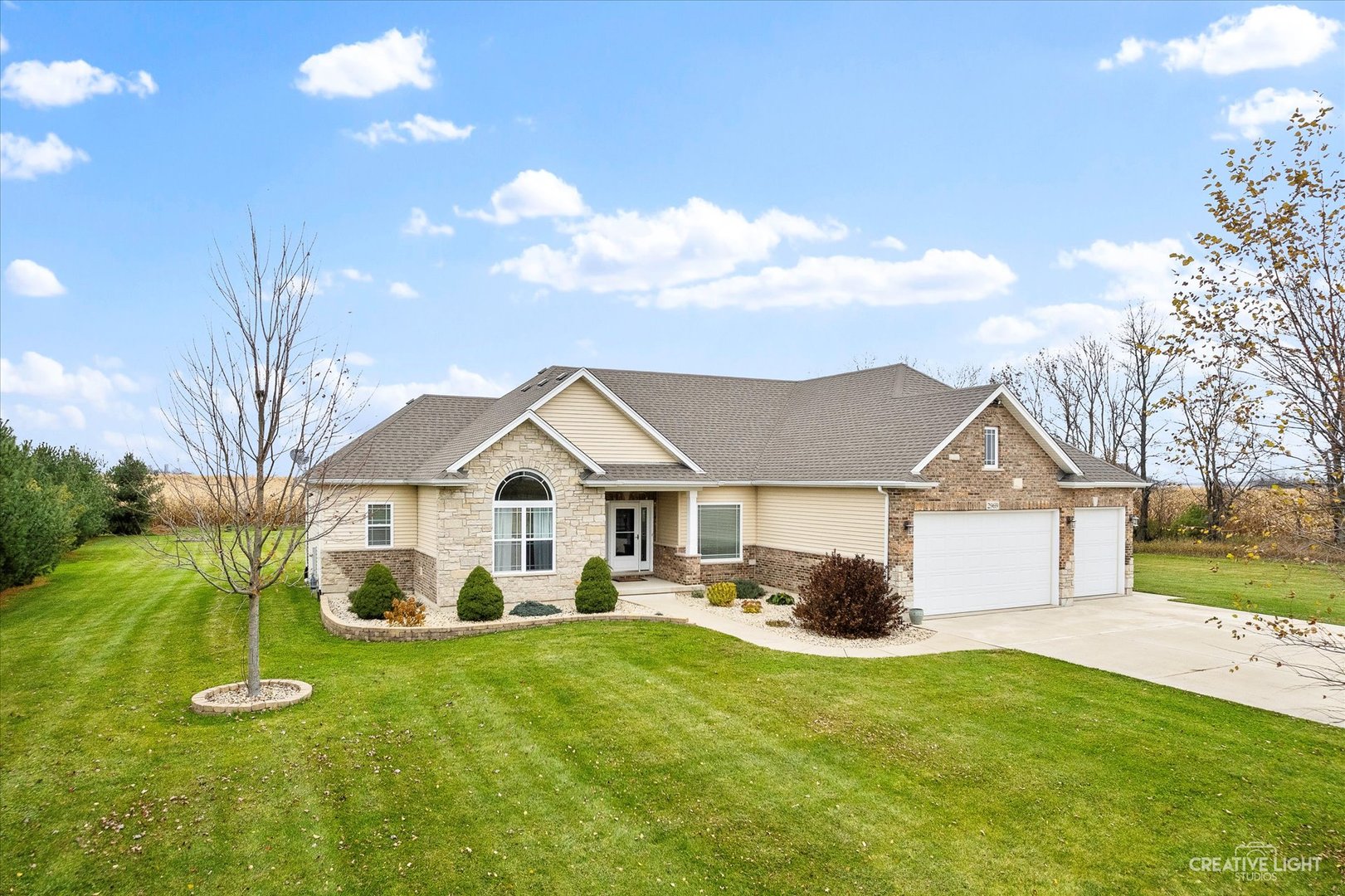 2969 4459th Road Newark, IL 60541 - Photo 26 of 35 a front view of a house with a garden and yard