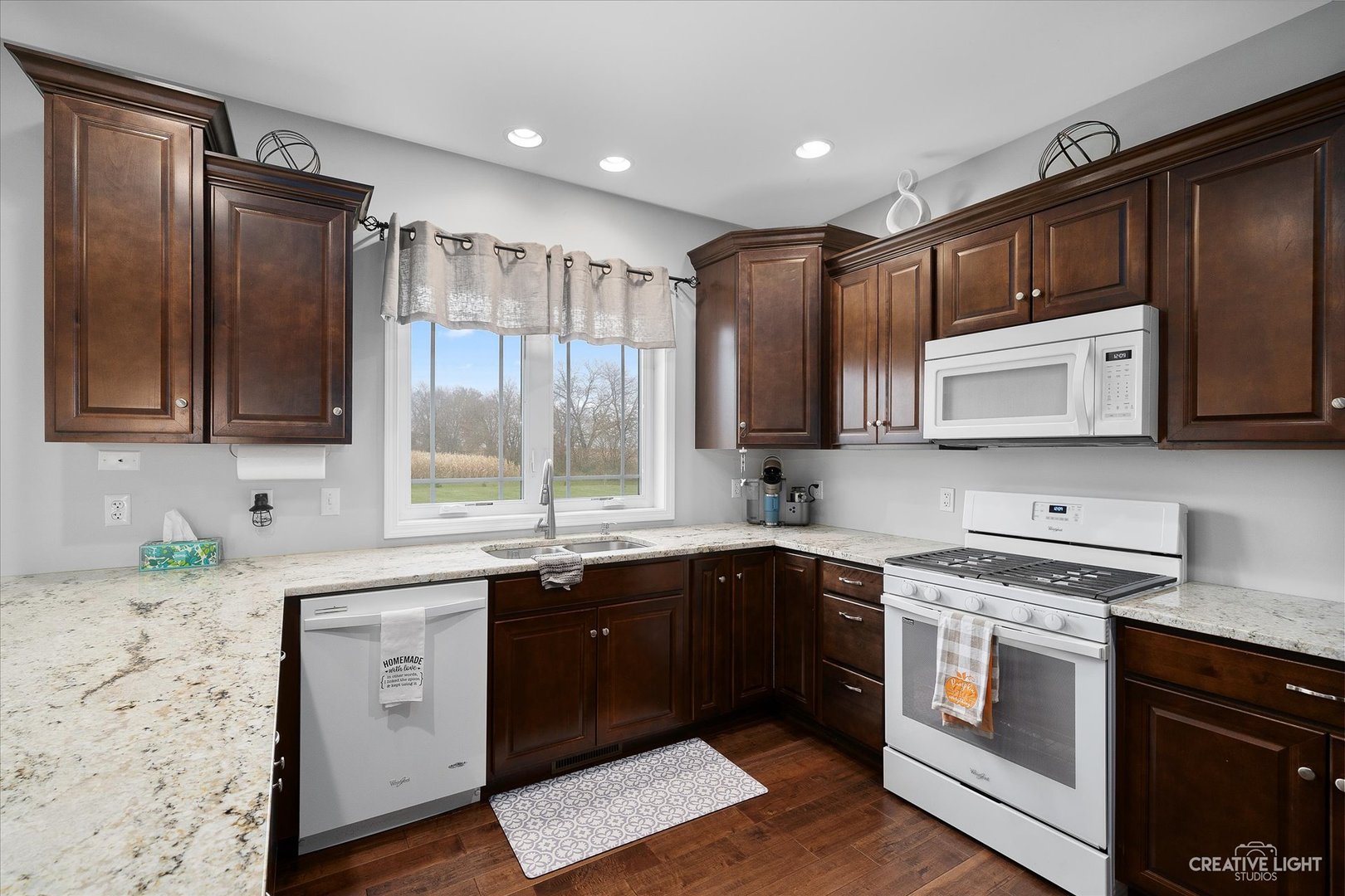 2969 4459th Road Newark, IL 60541 - Photo 5 of 35 a kitchen with stainless steel appliances granite countertop wooden cabinets and a stove top oven