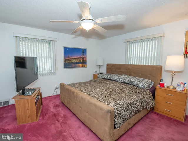 a bedroom with a large bed and a flat screen tv