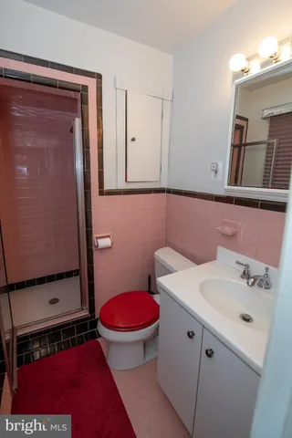 a bathroom with a sink a toilet and mirror